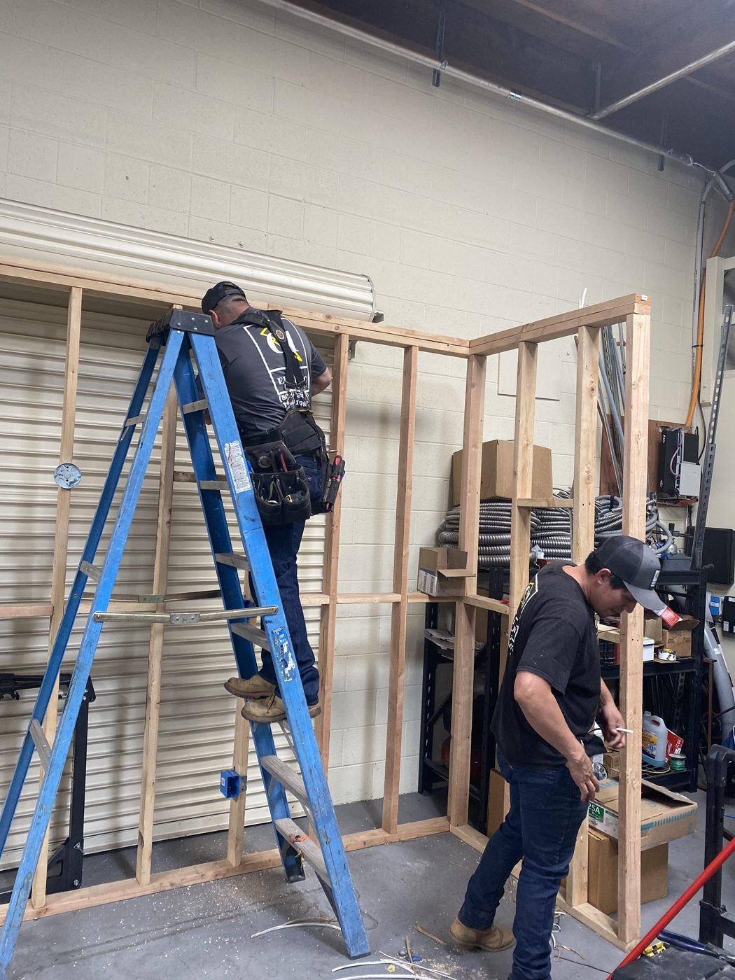 C1 Electric crew building a training wall in the shop
