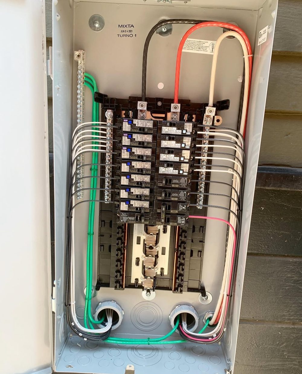 Exterior panel with neatly dressed and bundled conductors
